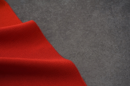 Red cloth with dark stone, background image の写真素材