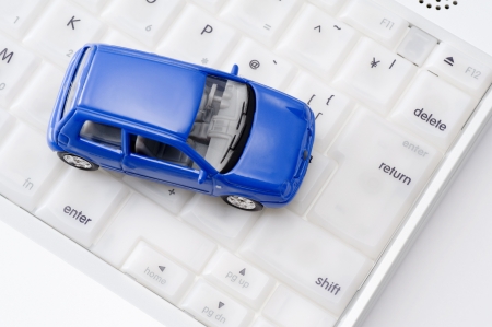 Personal computer and miniature car, close-up shoot の写真素材
