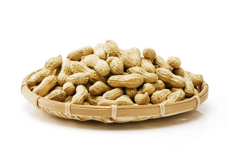 Many peanuts in basket isolated on white background