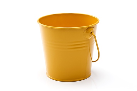 Yellow bucket of gardening tools on white backgroundの写真素材