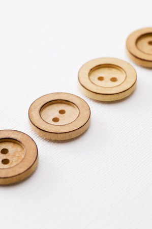 Wooden sewing buttons arranged in a straight lineの写真素材
