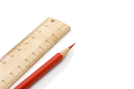 Wooden ruler and red pencil on yellow background の写真素材