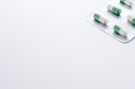 Green medical capsules in package, background image の写真素材