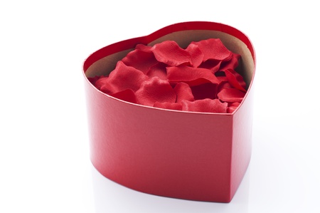 Red rose petals in heart shaped gift box 