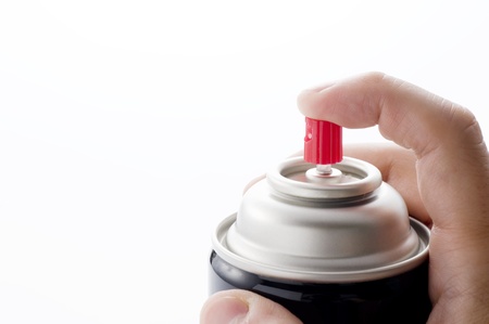 Male hand holding a spray can on white 