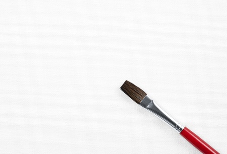 Paintbrush on blank white canvas, close-up の写真素材