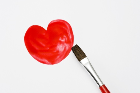 Draw a picture of a heart on paper with brush の写真素材