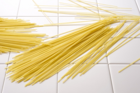 Spaghettis pasta on white tile in kitchen の写真素材