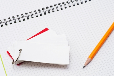 pencil and wordbook on open blank notebookの写真素材