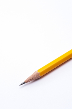 wooden orange pencil on white paper backgroundの写真素材