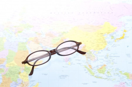 brown frame eyeglasses on world map backgroundの写真素材