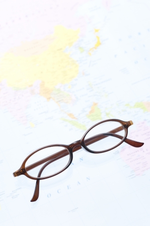brown frame eyeglasses on world map backgroundの写真素材