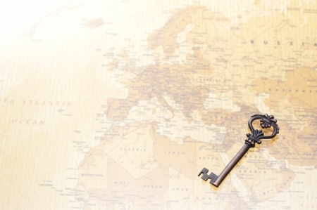 a antique key on world map backgroundの写真素材