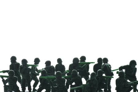 miniture toy soldiers with guns on white backgroundの写真素材