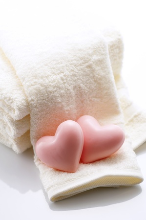 Heart-shaped soap and towelsの写真素材