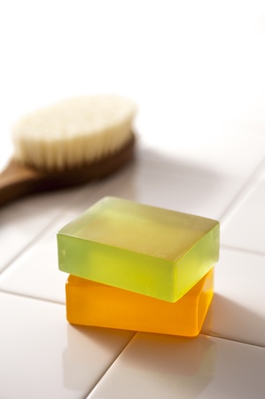 Body soap and brush on top of the tileの写真素材