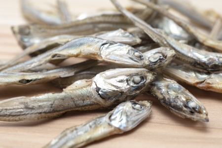 Dried sardine on wooden background の写真素材