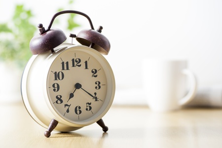 Traditional mechanical alarm clock on tableの写真素材