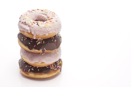 stacked chocolate donuts on white backgroundの写真素材