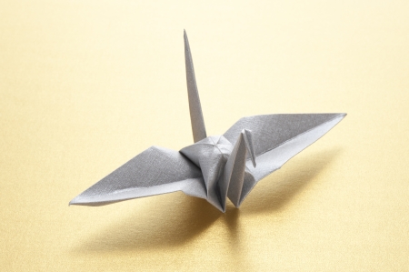 origami crane on gold backgroundの写真素材