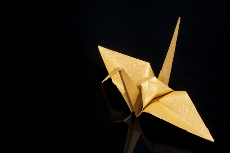 origami crane on black backgroundの写真素材