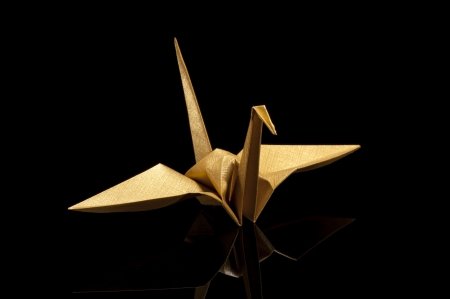 origami crane on black backgroundの写真素材