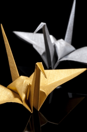 origami crane on black backgroundの写真素材