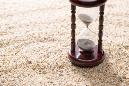 hourglass on sand background