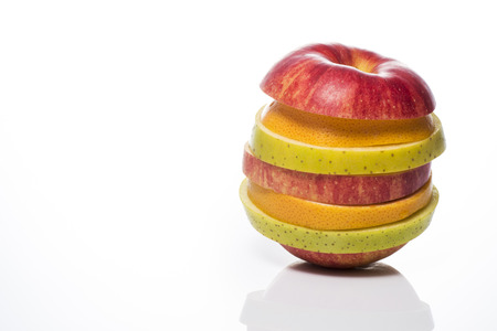 Piled up of cut fruit on white backgroundの写真素材