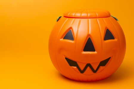 plastic jack-o-lantern on orange  backgroundの写真素材