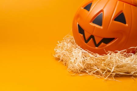 plastic jack-o-lantern on orange  backgroundの写真素材