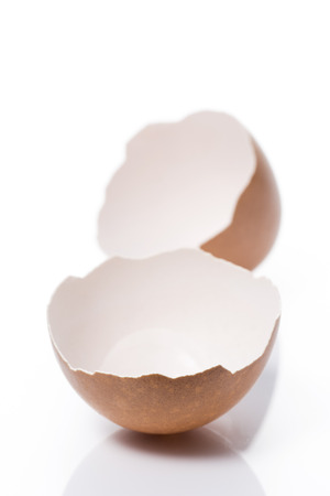 a cracked eggshell on white backgroundの写真素材