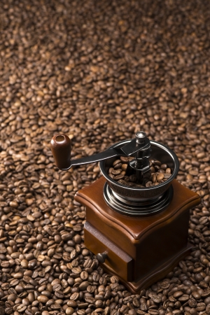 antique coffee grinder with coffee beansの写真素材