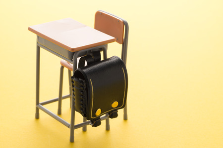school desk on yellow の写真素材