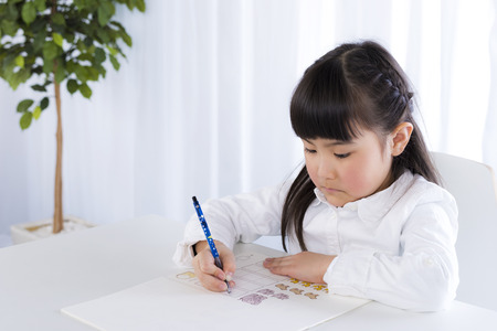 little girl is studying in houseの写真素材