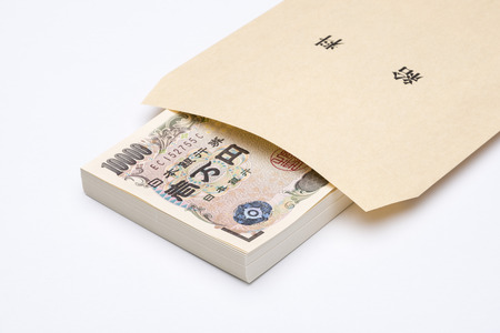 One million yen bills in pay envelopeの写真素材