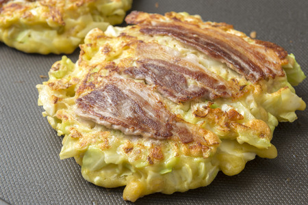 Okonomiyaki, a Japanese savoury pancake containing a variety ingredientsの写真素材