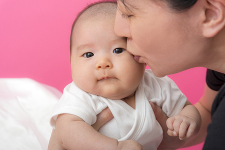 Mother kisses babyの写真素材