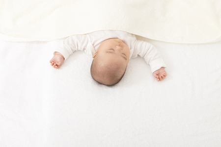 Baby sleeping in bedの写真素材