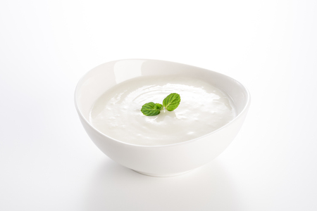 Yogurt in a bowl on white backgroundの写真素材