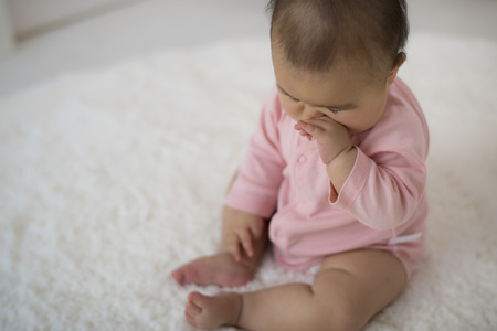 Sitting baby on matの写真素材