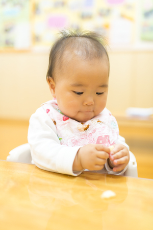 Baby eating snacksの写真素材