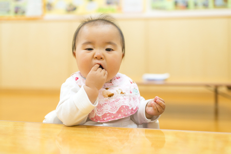 Baby eating snacksの写真素材