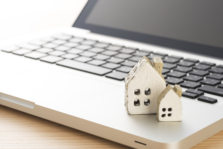 Laptop with Miniature Houseの写真素材