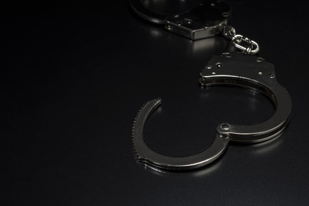 Handcuffs on black background