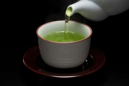 Hot green tea on dark backgroundの写真素材
