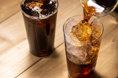 Pouring iced coffee into a glassの写真素材