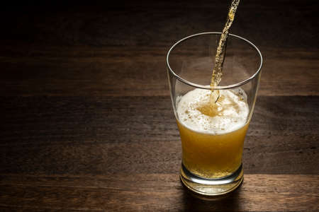 cold beer on wooden tableの写真素材