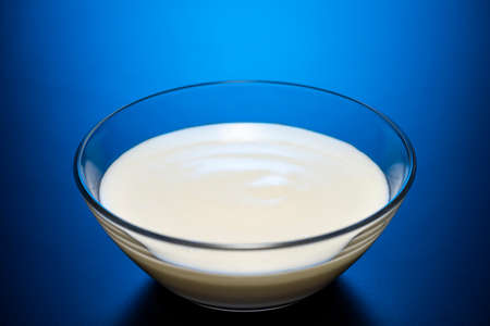Yogurt into a glass bowの写真素材