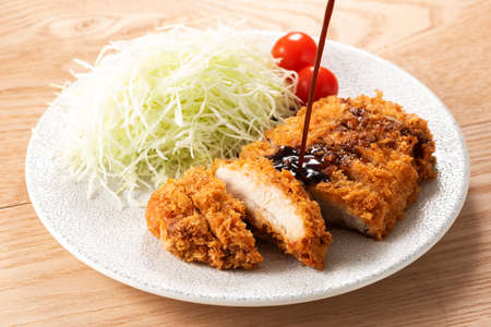 Delicious fried pork cutlet on tableの写真素材